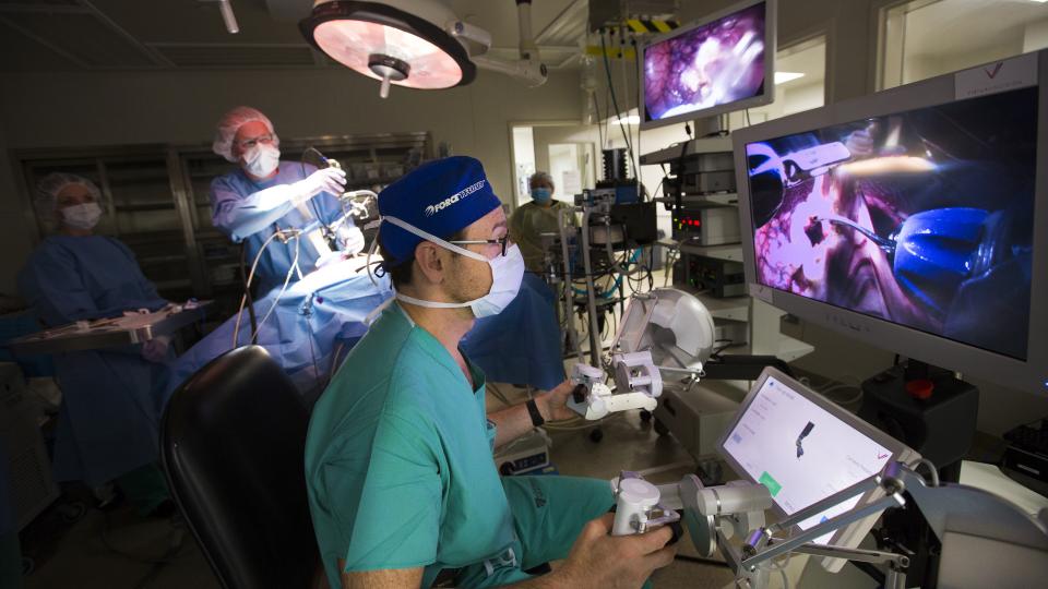 Dmitry Oleynikov, a professor of surgery at the University of Nebraska Medical Center, operates a surgical robot as in the background Shane Farritor, an engineering professor at the University of Nebraska-Lincoln, adjusts the camera on the surgical subject in June 2015. The two developed the robot for minimally invasive surgeries. Farritor and Oleynikov's startup company, Virtual Incisions, is joining Nebraska Innovation Campus.