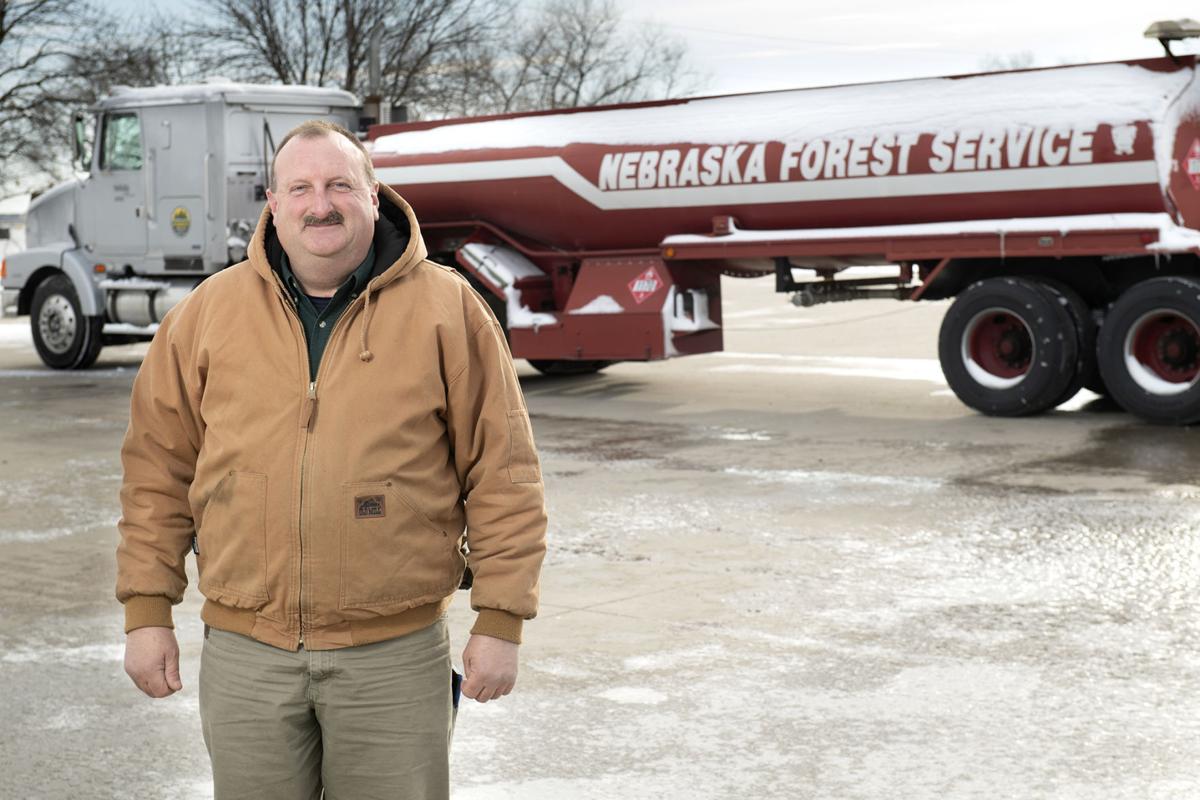 Lew Sieber, manager of the Nebraska Forest Service Fire Shop, with the tank truck he used to haul 200,000 gallons of ethanol across the state to be mixed into hand sanitizer.