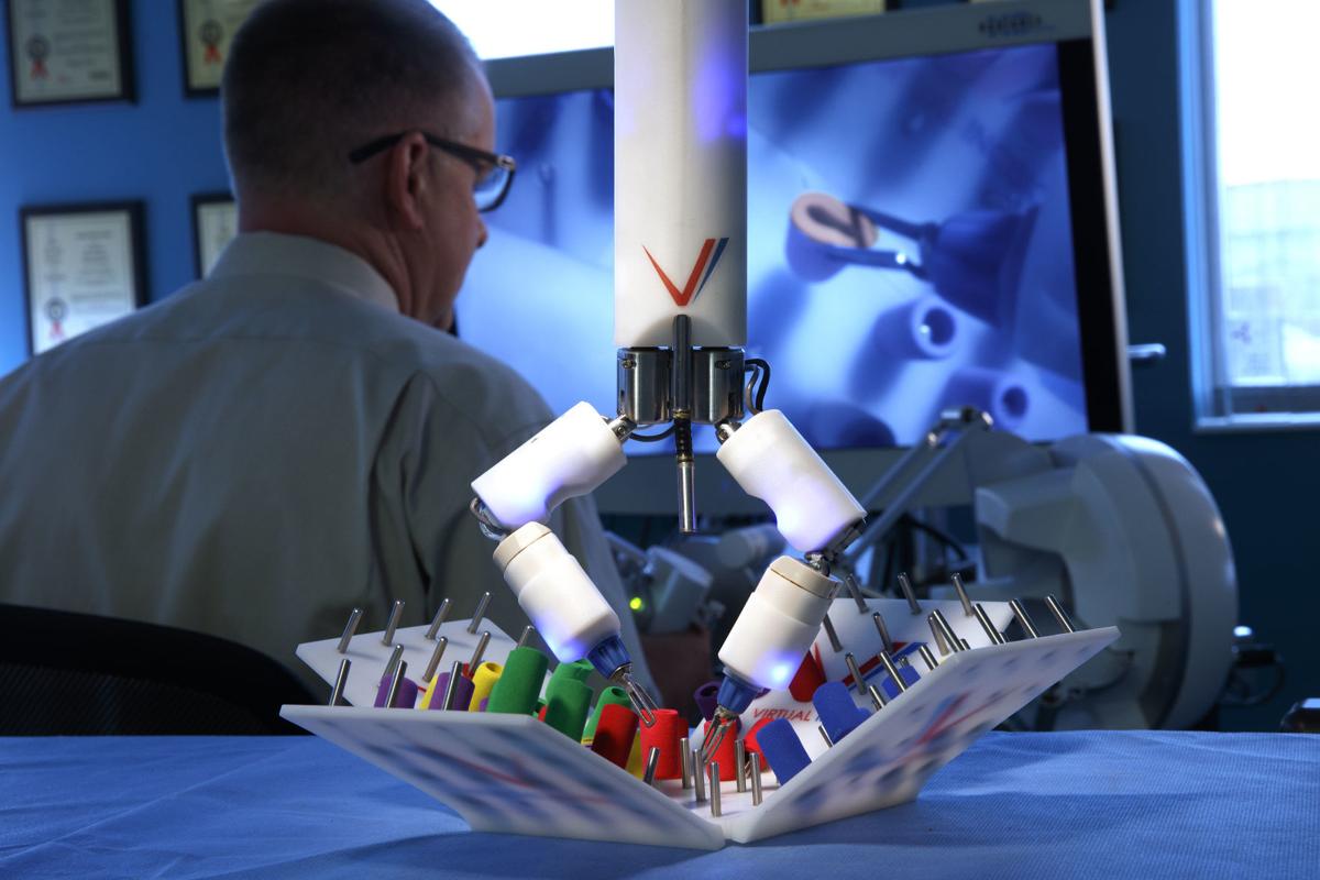 UNL professor Shane Farritor operates a Virtual Incision surgical robot in the group’s Nebraska Innovation Center office and lab.