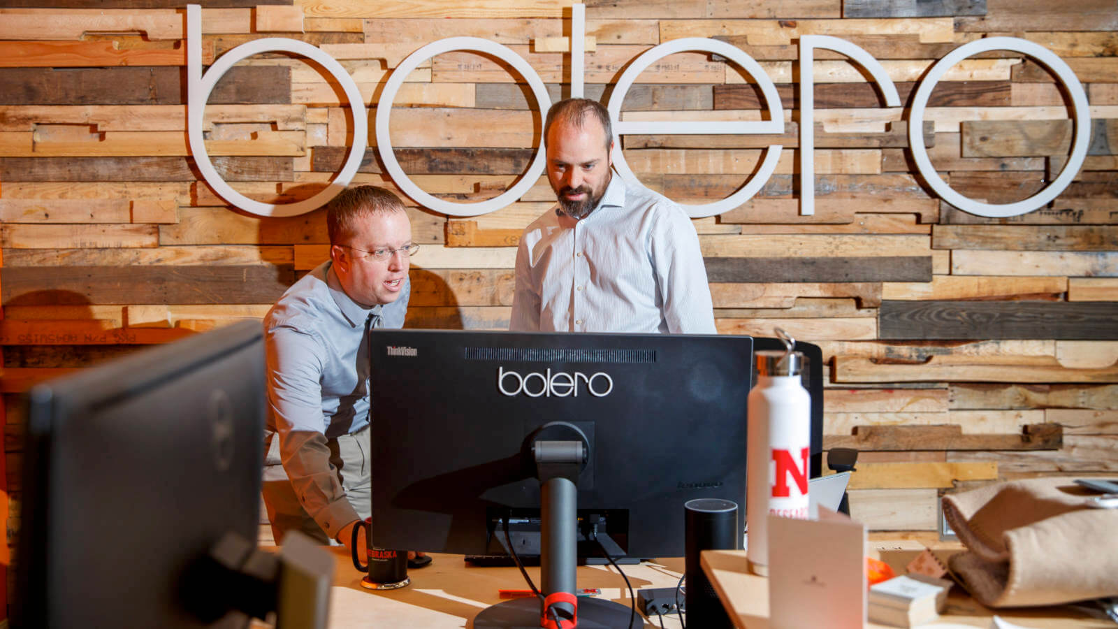 Bolero employees look at computer