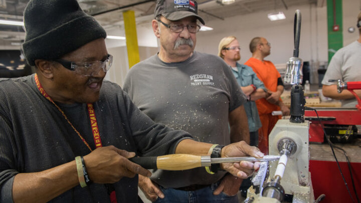 David Key and Richard Schaefer work on a lathe at Nebraska Innovation Studio. 