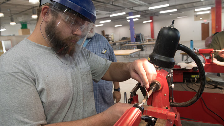 Bryan Jones of Lincoln, a veteran of the United States Navy, uses a lathe in Nebraska Innovation Studio. 