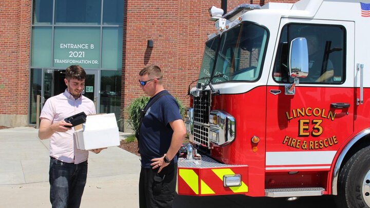 Max Wheeler, instructional designer at Nebraska Innovation Studio, shows a new 3D-printed case for a video laryngoscope to firefighter-paramedic Brennan Oliverius at Nebraska Innovation Campus.