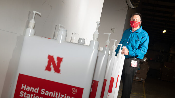 Jim Jackson, associate vice chancellor of University Operations, put a team together to solve the problem of efficiently distributing hand sanitizer across campus. They invented the large-capacity, free-standing dispenser station shown here. 