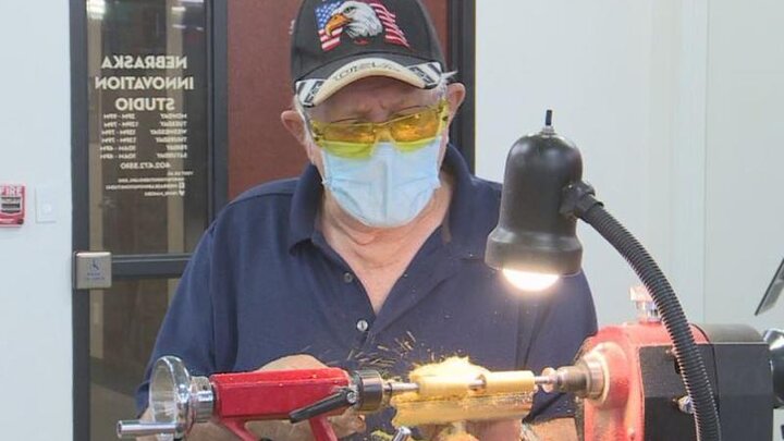 A veteran turns a pen on a midi lathe at Nebraska Innovation Studio.
