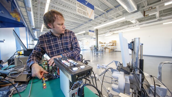 Jason Dumpert works with components in the console assembly area.