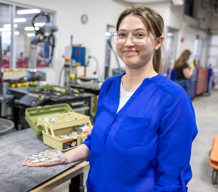 Teresa Monsees holds the prototype of a robotic hand that will sign the alphabet. 